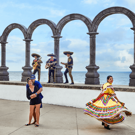 Image of couple dancing with mariachi band in Puerto Vallarta. Click to watch video.