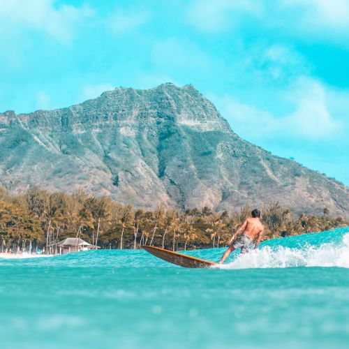 Diamond Head in background with surfer on ocean