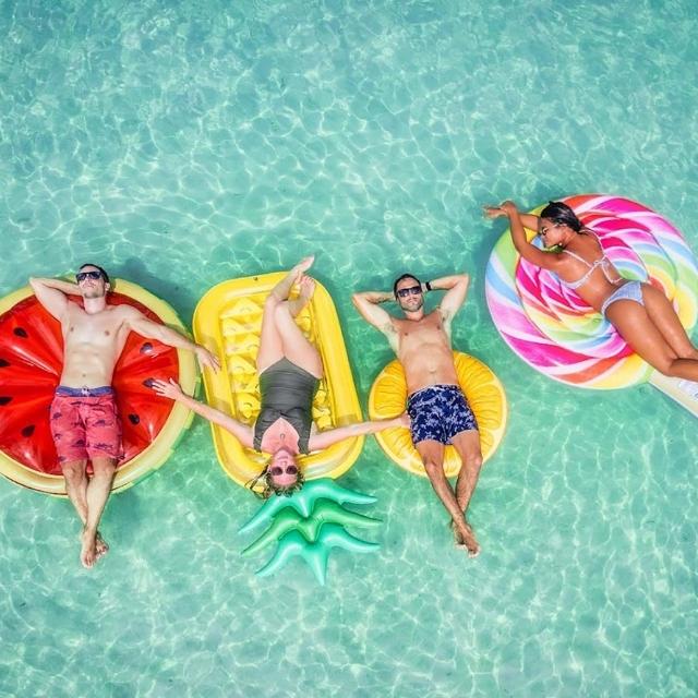 Four people on colorful ocean floaties