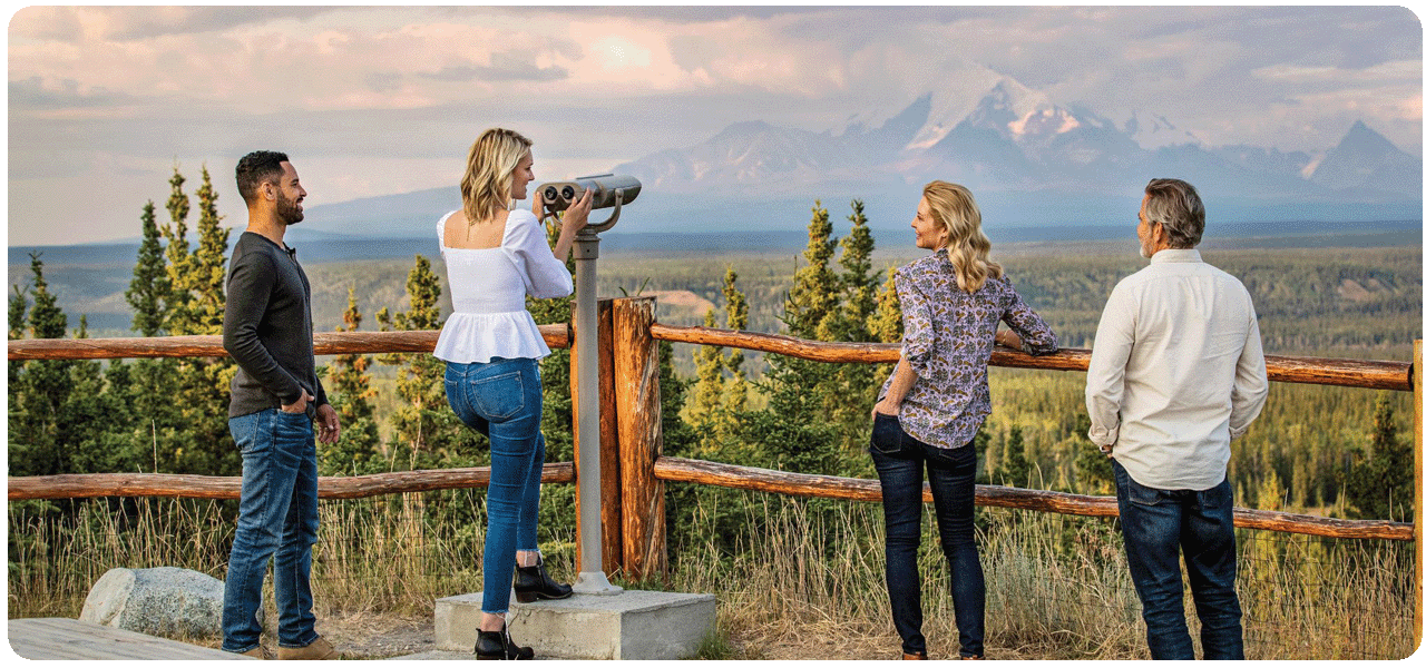 Couple observing the snow capped mountains with binoculars at the Copper River Princess Wilderness Lodge. Click here to learn more.
