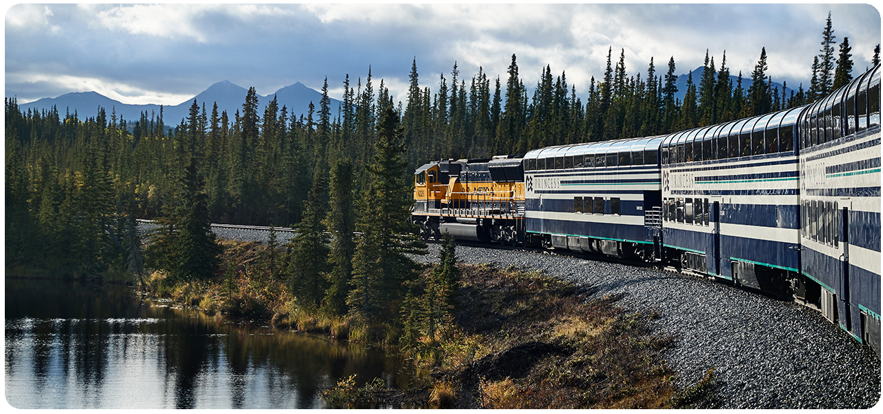 Couple observing the snow capped mountains with binoculars at the Copper River Princess Wilderness Lodge. Click here to learn more.